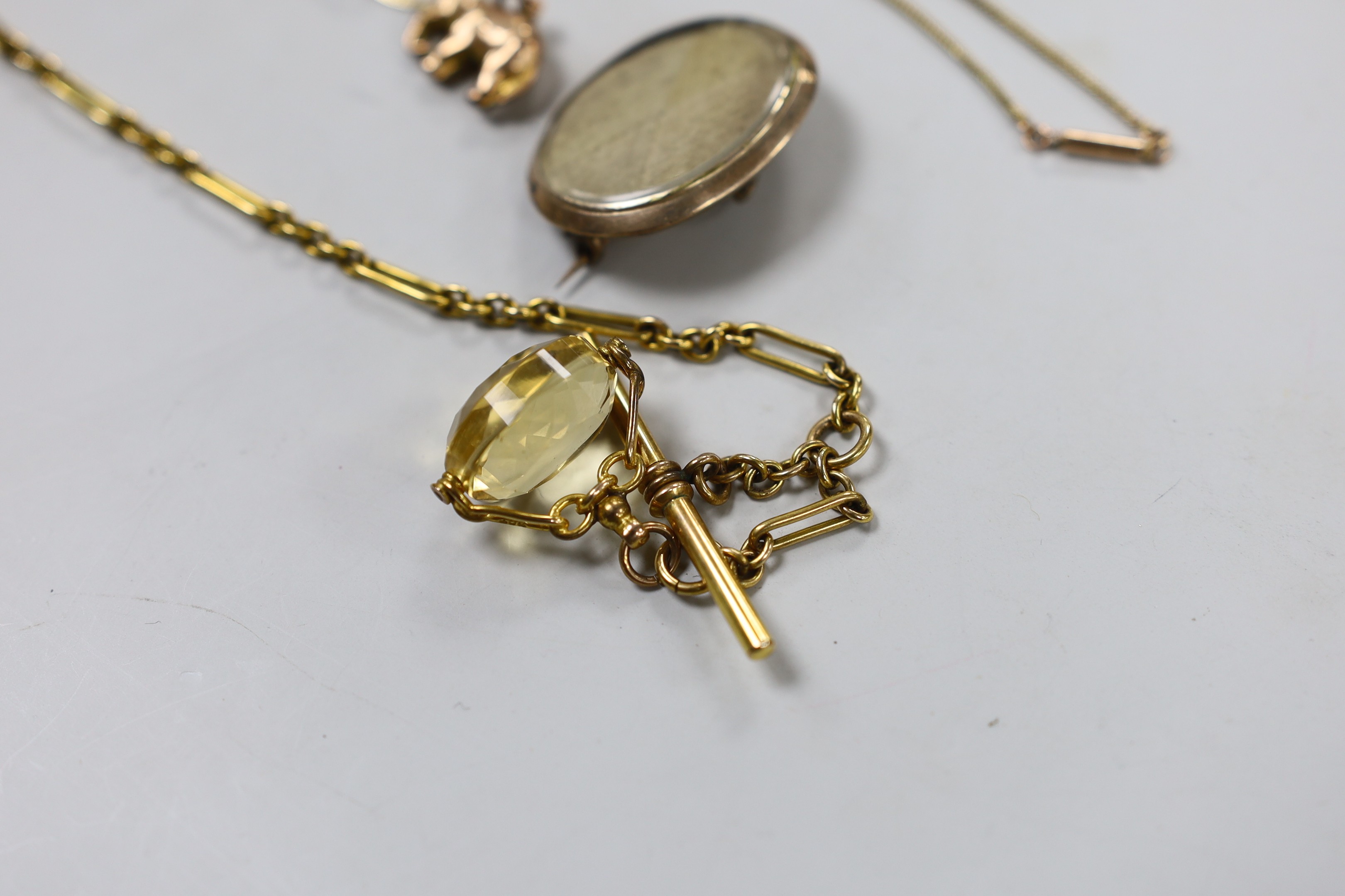 A small collection of Victorian and later jewellery, including two fob seals, two yellow metal charms, a 9ct pendant on a yellow metal chain, mourning pendant, gilt metal albert and a gem set yellow metal foliate brooch.